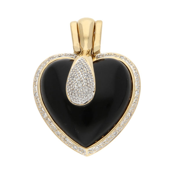 Dije diseño especial motivo corazón con diamantes y ónix en oro amarillo 14 kilates.