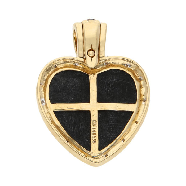 Dije diseño especial motivo corazón con diamantes y ónix en oro amarillo 14 kilates.