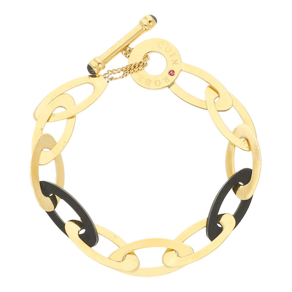 Pulsera eslabón cruzado firma Roberto Coin con aplicaciones de Rubí, caucho, y sintéticos en oro amarillo 18 kilates.