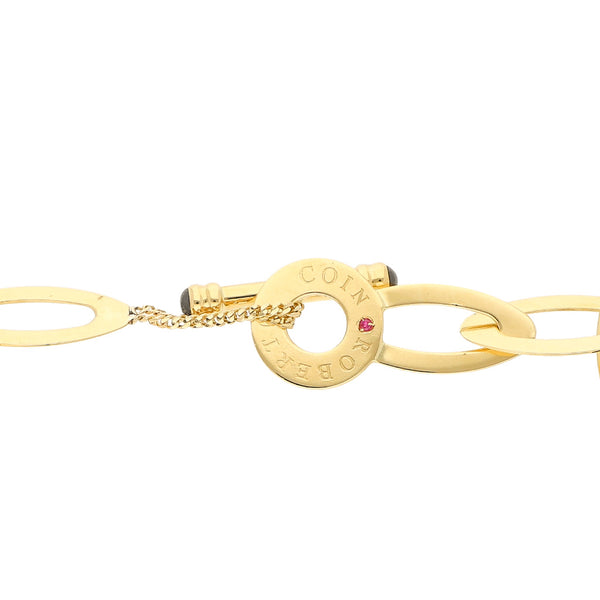 Pulsera eslabón cruzado firma Roberto Coin con aplicaciones de Rubí, caucho, y sintéticos en oro amarillo 18 kilates.