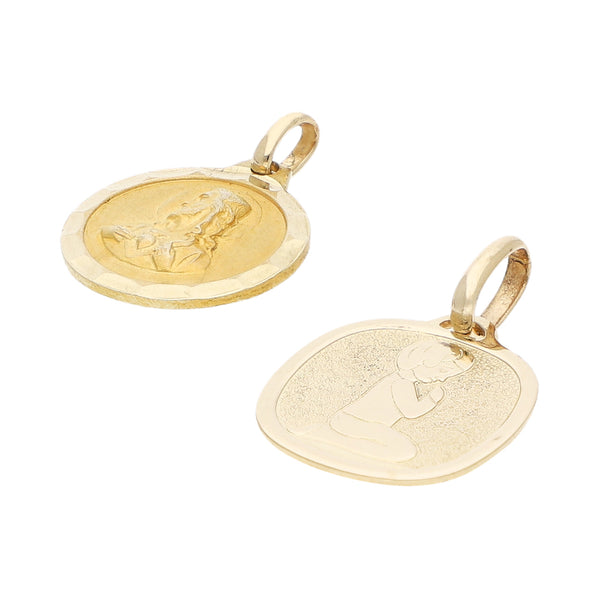 Dos medallas infantiles diseño especial motivo Sagrado Corazón y Primera Comunión en oro amarillo 14 kilates.