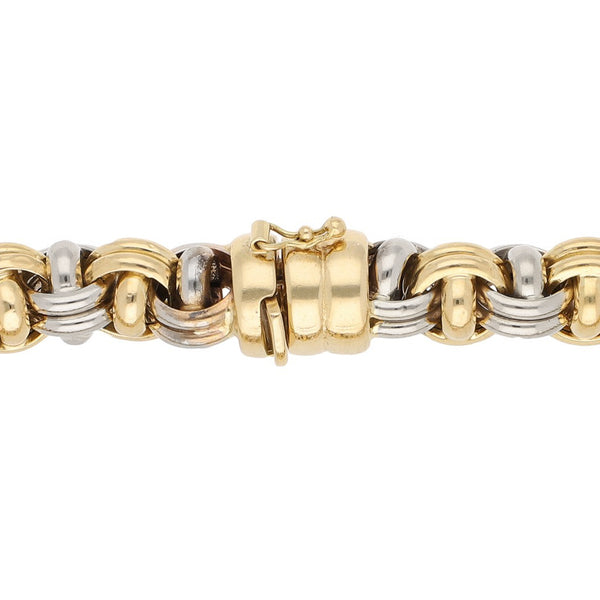 Pulsera eslabón tejido en oro dos tonos 18 kilates.