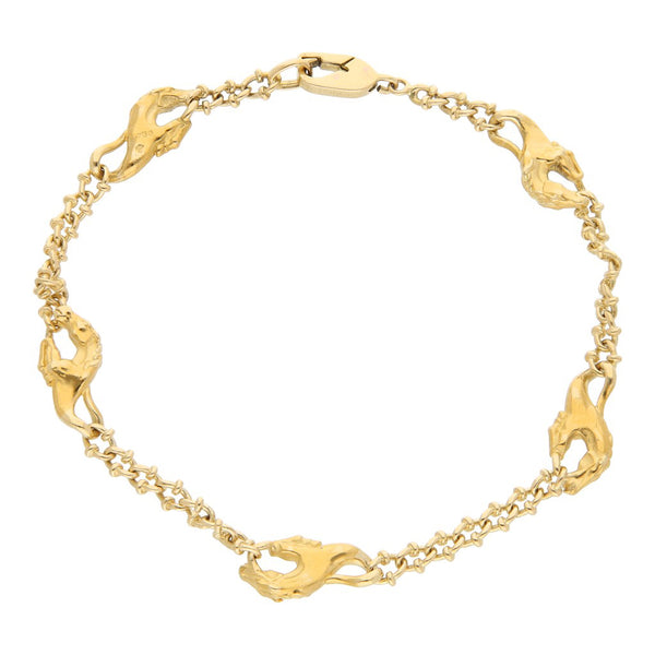 Pulsera eslabón encontrado con aplicaciones motivo caballo firma Carrera y Carrera en oro amarillo 18 kilates.