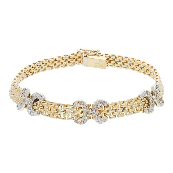 Pulsera eslabón articulado con aplicaciones de diamantes en oro dos tonos 14 kilates.