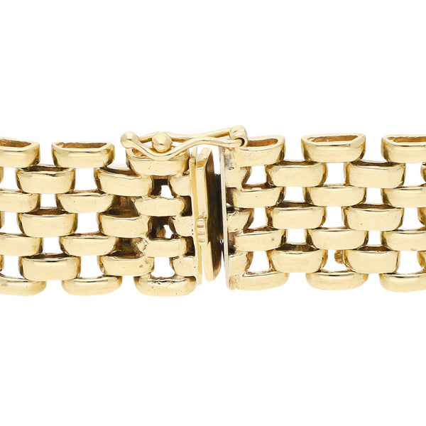 Pulsera eslabón articulado con aplicación motivo pantera en oro dos tonos 14 kilates.