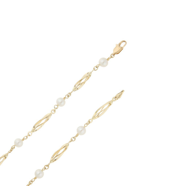 Gargantilla eslabón articulado con aplicaciones de perlas en oro amarillo 14 kilates.