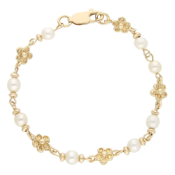 Pulsera eslabón combinado motivo flor con perlas en oro amarillo 14 kilates.