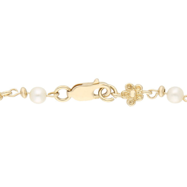 Pulsera eslabón combinado motivo flor con perlas en oro amarillo 14 kilates.