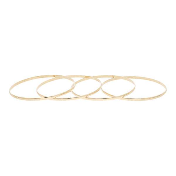 Cuatro pulseras de arillo lisas en oro amarillo 14 kilates.