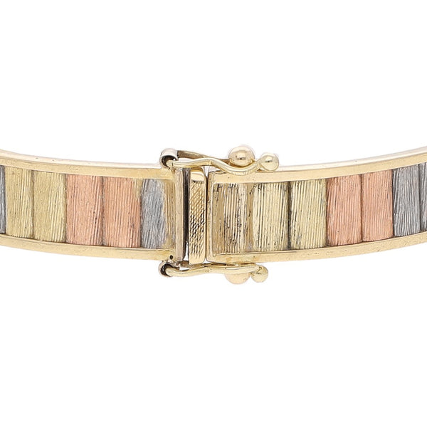 Pulsera de arillo articulada en oro tres tonos 14 kilates.