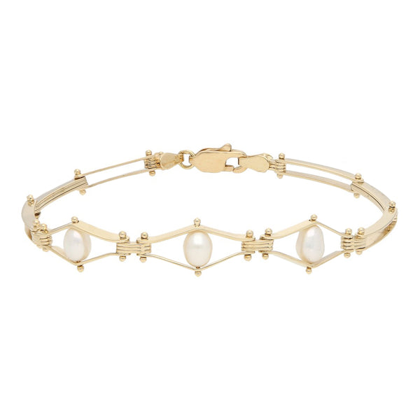 Pulsera eslabón articulado con perlas en oro amarillo 14 kilates.