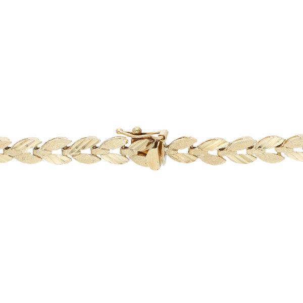 Pulsera eslabón articulado motivo hojas en oro amarillo 14 kilates.