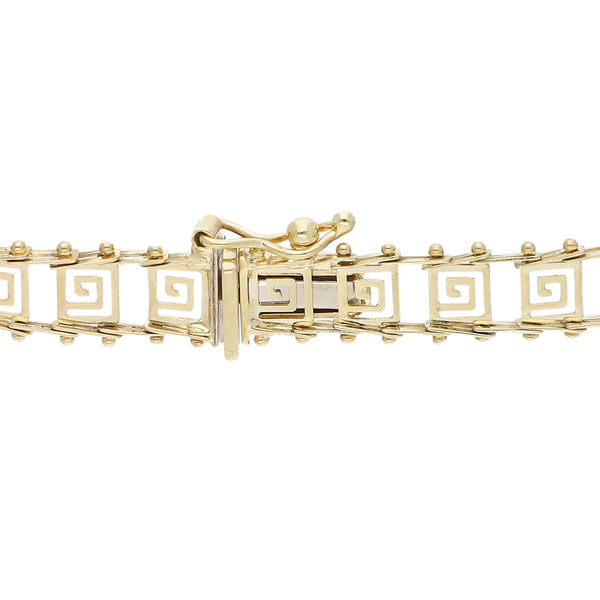 Pulsera eslabón boleado motivo grecas en oro amarillo 14 kilates.