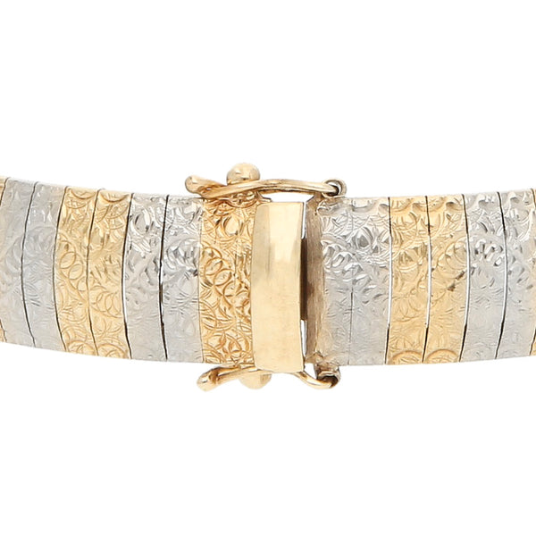 Pulsera eslabón articulado en oro dos tonos 14 kilates.