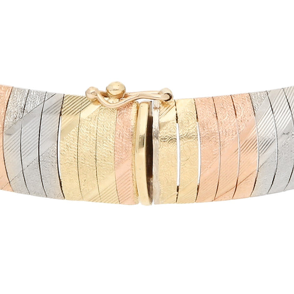 Pulsera eslabón articulado en oro tres tonos 14 kilates.