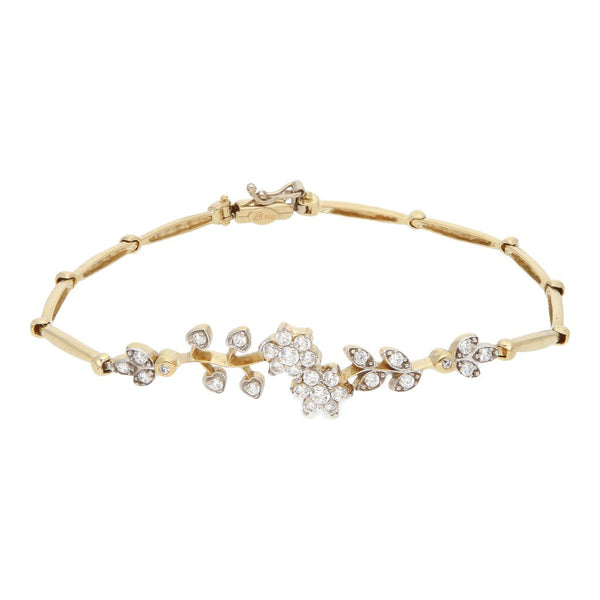 Pulsera eslabón articulado con sintéticos motivo flores en oro amarillo 14 kilates.