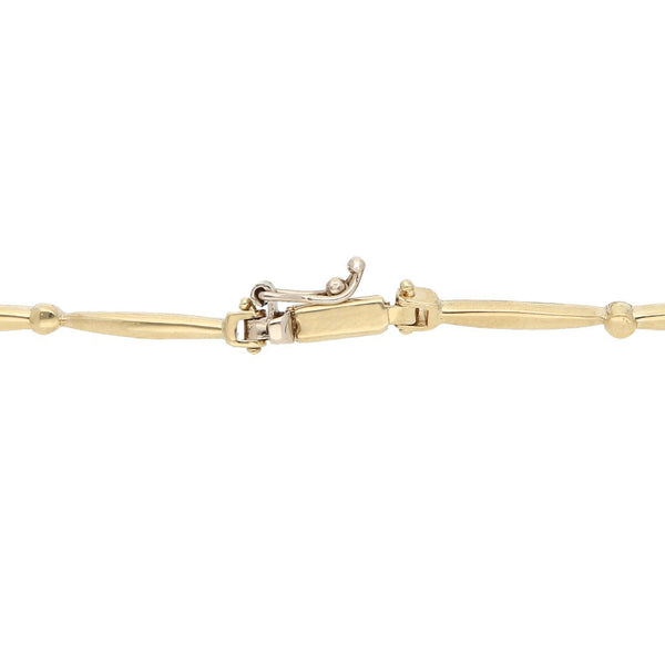 Pulsera eslabón articulado con sintéticos motivo flores en oro amarillo 14 kilates.