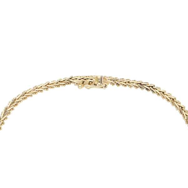 Pulsera boleada en oro tres tonos 14 kilates.