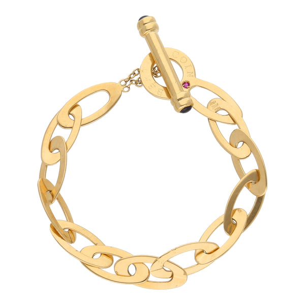 Pulsera eslabón cruzado con sintéticos en oro amarillo 18 kilates.