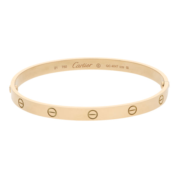 Pulsera de arillo articulada firma Cartier motivo tornillos simulados en oro amarillo 18 kilates.