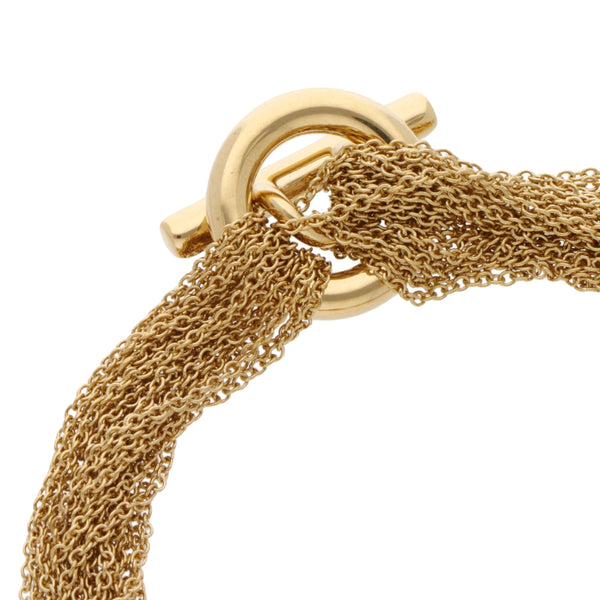 Pulsera eslabón cruzado en hilos motivo corazón firma Tiffany & Co. en oro amarillo 18 kilates.