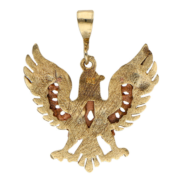 Dije hechura especial motivo águila en oro tres tonos 14 kilates.