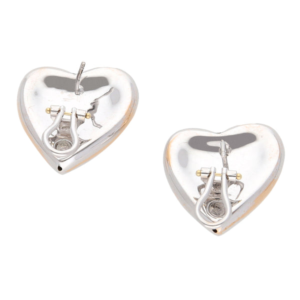 Aretes huecos motivo corazón en oro blanco 14 kilates.