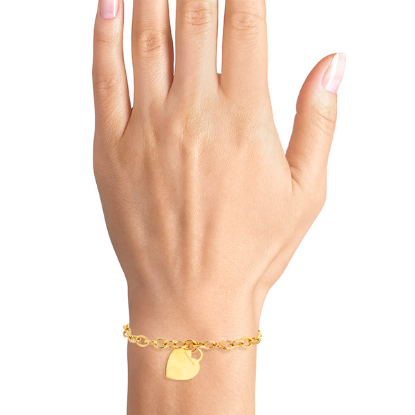 Pulsera eslabón cruzado con pendiente motivo corazón firma Tiffany & Co. en oro amarillo 18 kilates.