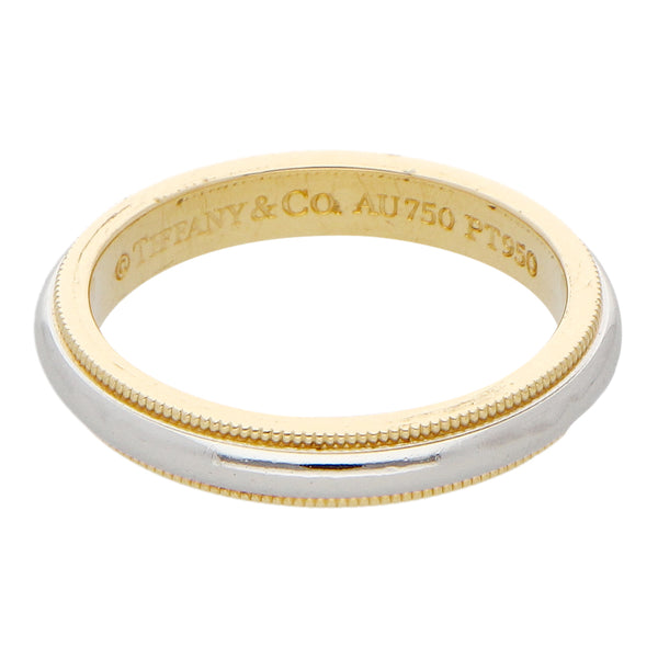 Argolla media caña firma Tiffany & Co. en platino y oro amarillo 18 kilates.