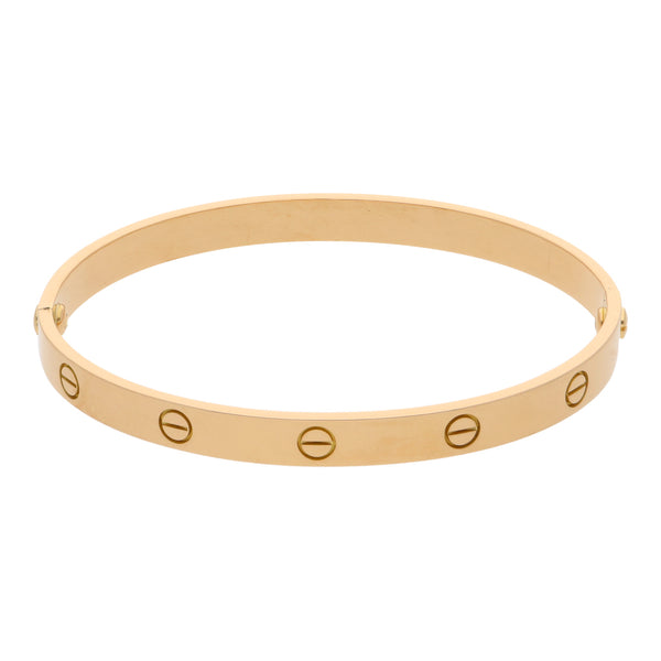 Brazalete articulado motivo tornillos simulados firma Cartier en oro amarillo 18 kilates.