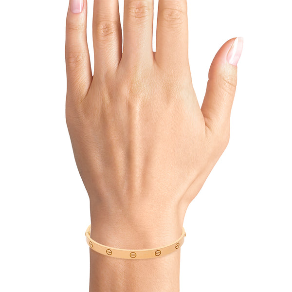 Brazalete articulado motivo tornillos simulados firma Cartier en oro amarillo 18 kilates.