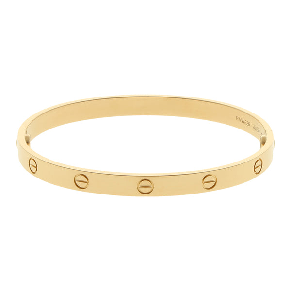 Brazalete rígido articulado motivo tornillos simulados firma Cartier en oro amarillo 18 kilates.