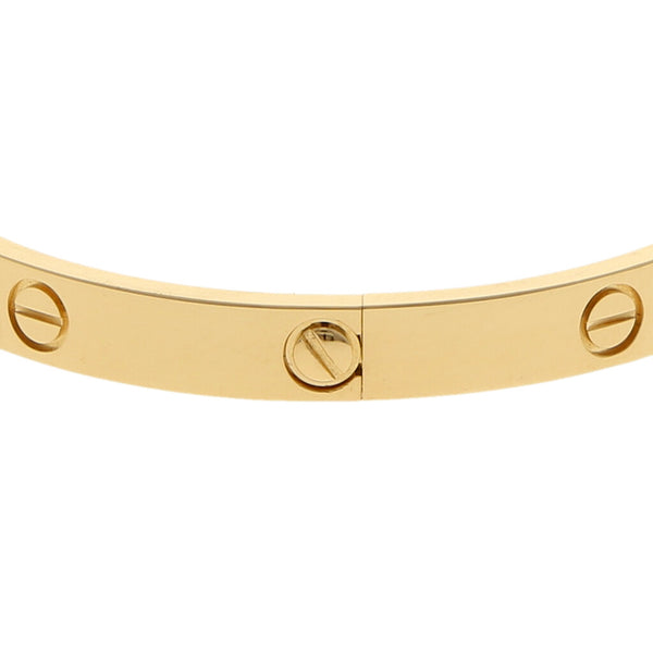 Brazalete rígido articulado motivo tornillos simulados firma Cartier en oro amarillo 18 kilates.