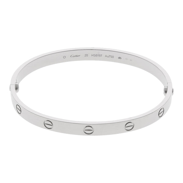 Brazalete hechura especial motivo tornillo firma Cartier en oro blanco 18 kilates.