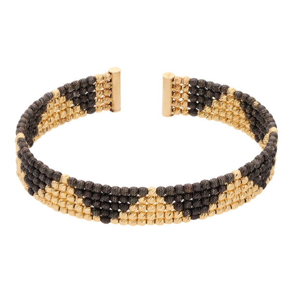 Pulsera hechura italiana abierta boleada con esmalte en oro amarillo 14 kilates.