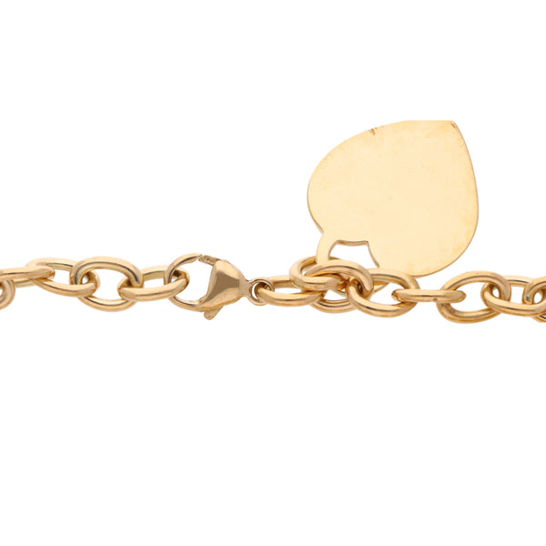 Pulsera eslabón cruzado firma Tiffany & Co. con dos pendientes motivo corazón en oro amarillo 18 kilates.