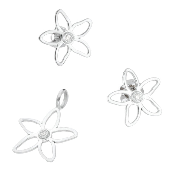 Juego de dije y broqueles hechura especial motivo floral con diamantes en oro blanco 18 kilates.