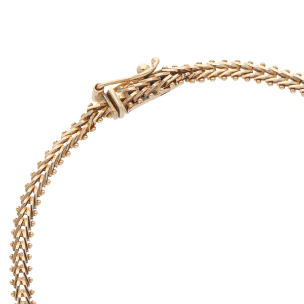 Pulsera boleada en oro tres tonos 14 kilates.