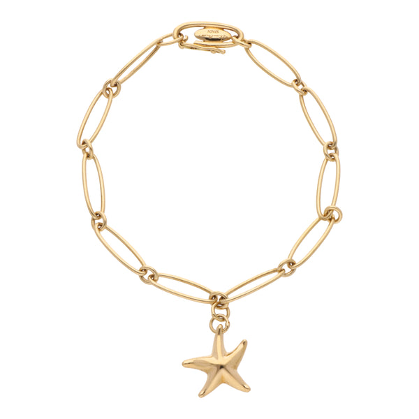 Pulsera eslabón ovalado con dije motivo estrella firma Tiffany & Co. en oro amarillo 18 kilates.