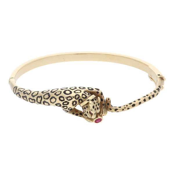 Pulsera de arillo articulada motivo jaguar con sintéticos y esmalte en oro amarillo 14 kilates.