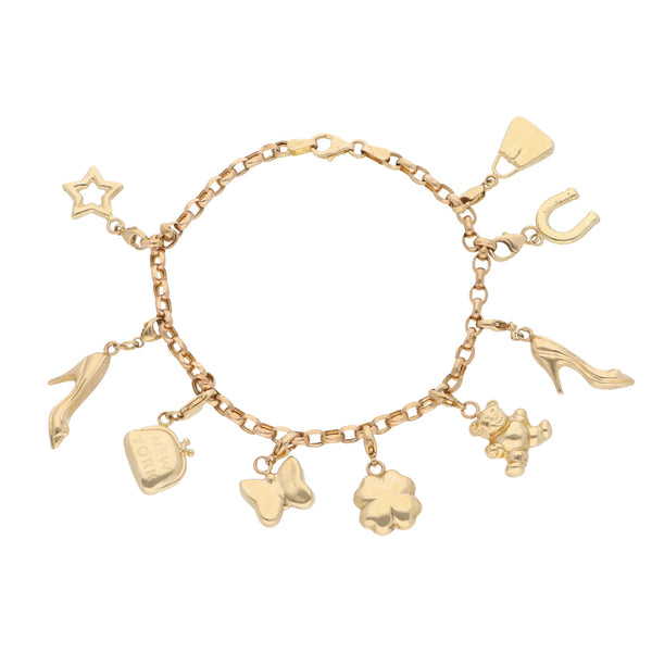 Pulsera eslabón cruzado con nueve dijes en oro amarillo 14 kilates.