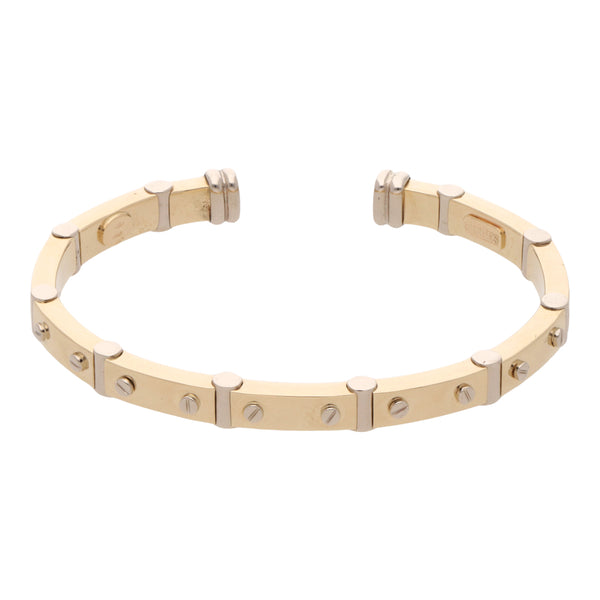 Pulsera abierta motivo tornillos simulados en oro dos tonos 14 kilates.