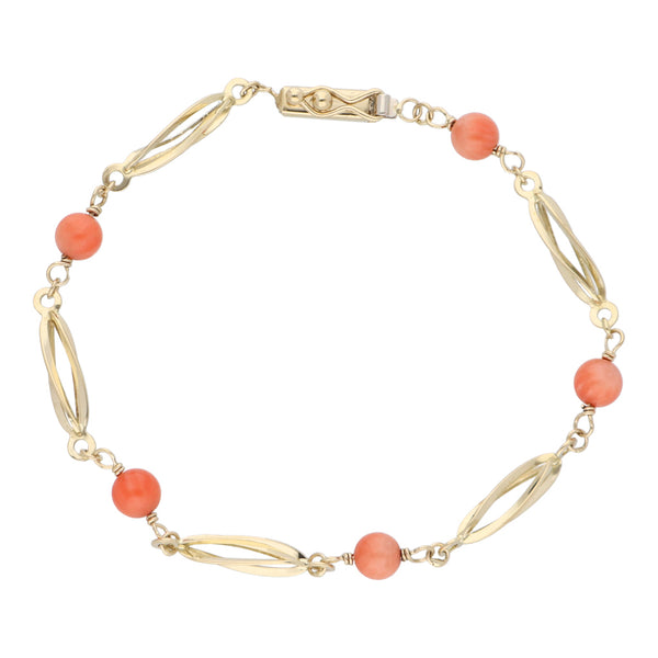 Pulsera eslabón combinado con coral en oro amarillo 14 kilates.