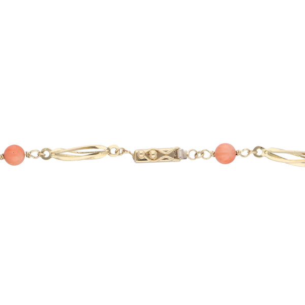 Pulsera eslabón combinado con coral en oro amarillo 14 kilates.