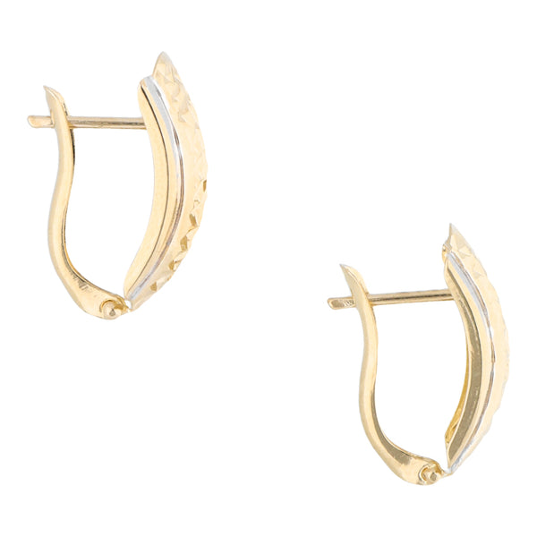 Aretes hechura especial en oro dos tonos 14 kilates.