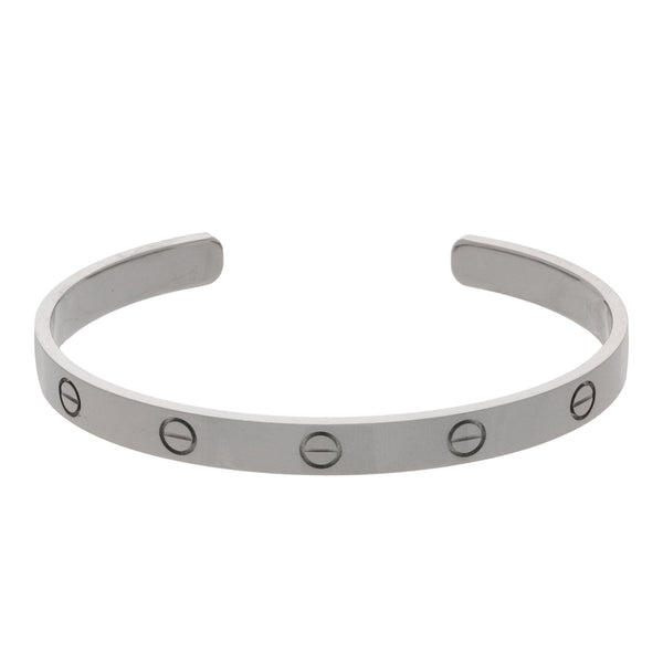 Pulsera de arillo abierta motivo tornillos simulados firma Cartier en oro blanco 18 kilates.