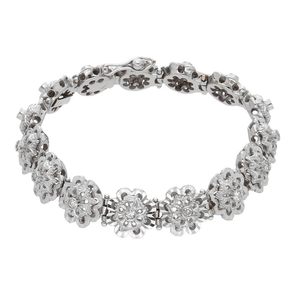 Pulsera eslabón articulado motivo flores con diamantes en oro blanco 18 kilates.