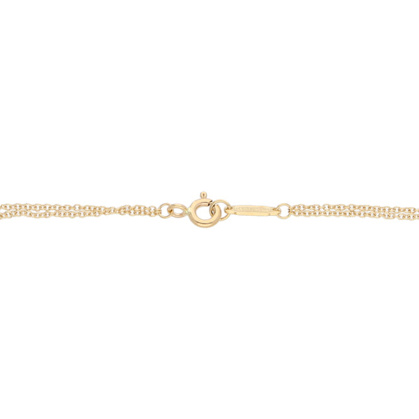 Pulsera dos hilos eslabón cruzado motivo infinito firma Tiffany & Co. en oro amarillo 18 kilates.