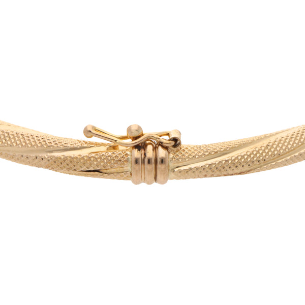 Pulsera de arillo articulada torzal en oro amarillo 14 kilates.