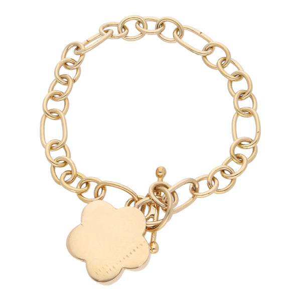 Pulsera eslabón combinado con dije motivo flor en oro amarillo 14 kilates.